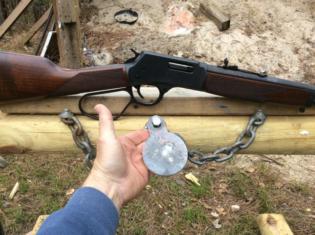nailing that 3 inch steel from 30 yds with ghost ring sight.jpg