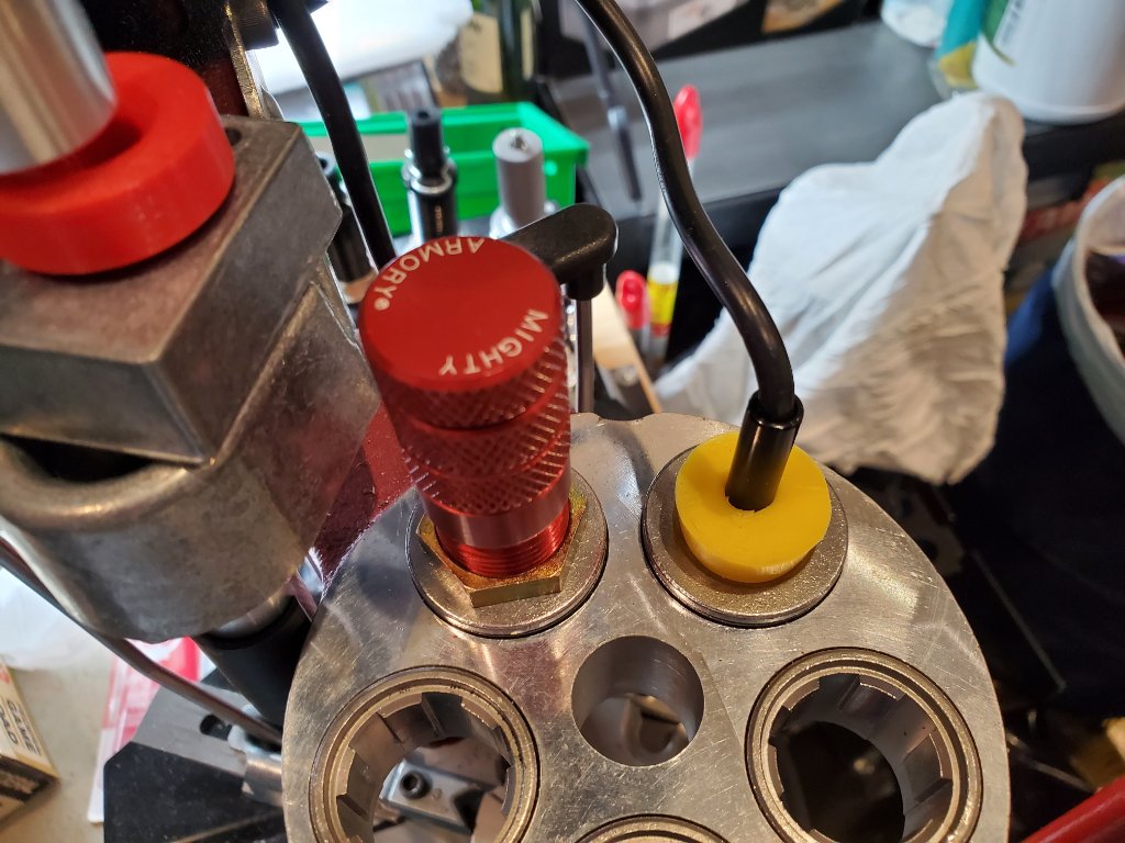 Red Mighty Armory Universal Decap Die and the silicone plug with the endoscope camera inserted.