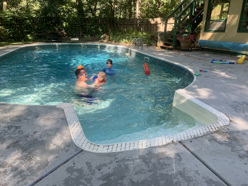 My son in law in the pool with his son and my G Grenddaughter