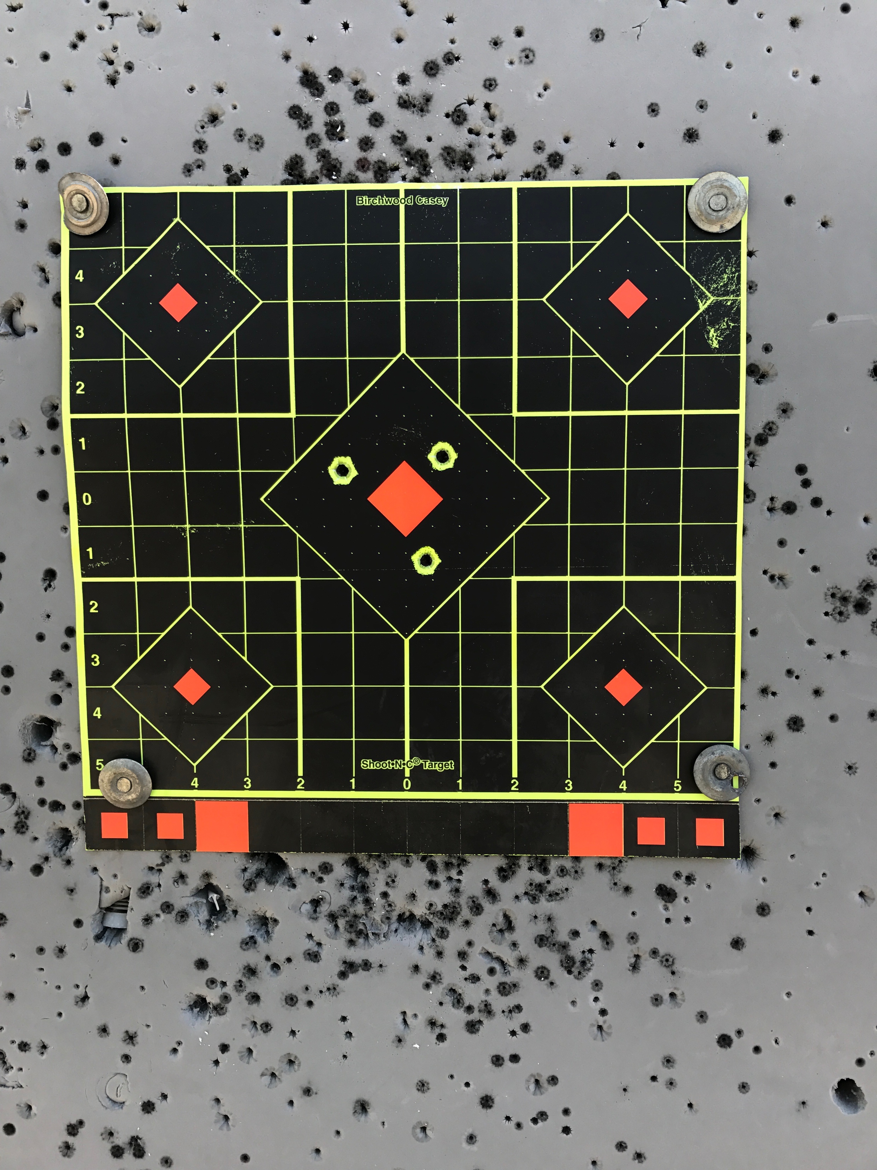 First three shots from bench at 53 yards (1 x 1" red center target).  Without 8 power binoculars, I had no idea!
